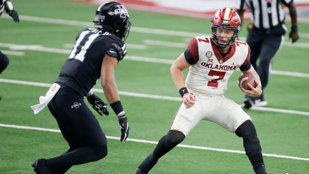 Oklahoma's Spencer Rattler (7) tries to runs past Iowa State's Lawrence White IV (11) during the Big 12 Championship Game between the University of Oklahoma Sooners (OU) and the Iowa State Cyclones at AT&T Stadium in Arlington, Texas, Saturday, Dec. 19, 2020. Oklahoma won 27-21. [Bryan Terry/The Oklahoman